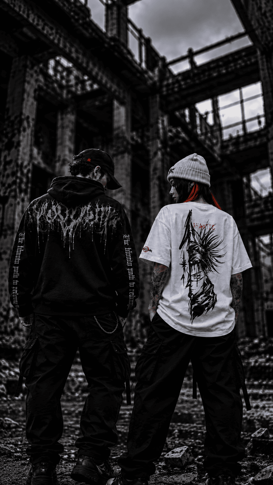 Two members of the KHAOTIC community wearing original graphic streetwear in an abandoned warehouse